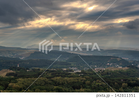 View of the mountains and Kislovodsk from the observation decks of the Kislovodsk Park. Evening sunset over the mountains of Kislovodsk. View of the mountains and Kislovodsk from the observation decks of the Kislovodsk Park. Evening sunset over the mountains of Kislovodsk. 142811351