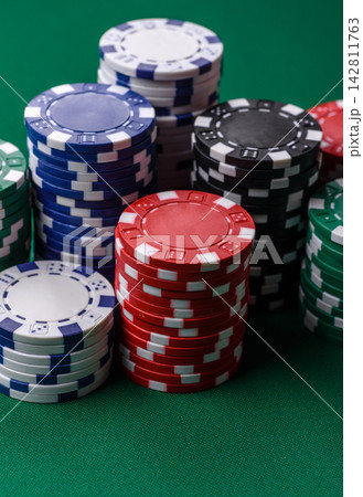Multi colored gaming chips for betting in casino games. Betting chips Multi colored gaming chips for betting in casino games. Betting chips 142811763
