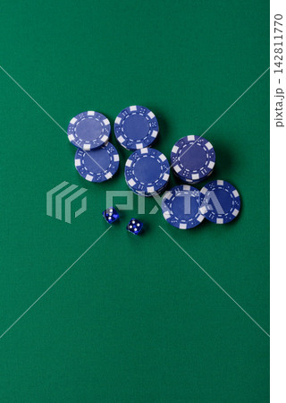 Multicolored casino chips as a conceptual backdrop for gambling games like poker, blackjack Multicolored casino chips as a conceptual backdrop for gambling games like poker, blackjack 142811770