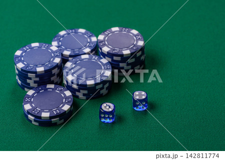 Multicolored casino chips as a conceptual backdrop for gambling games like poker, blackjack 142811774