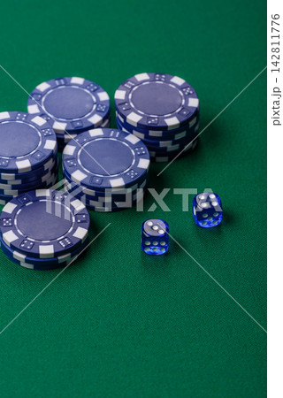 Multicolored casino chips as a conceptual backdrop for gambling games like poker, blackjack 142811776