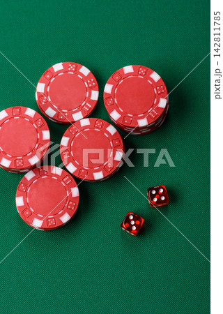 Multicolored casino chips as a conceptual backdrop for gambling games like poker, blackjack Multicolored casino chips as a conceptual backdrop for gambling games like poker, blackjack 142811785