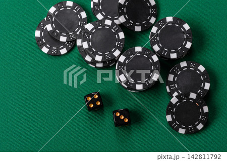 Multicolored casino chips as a conceptual backdrop for gambling games like poker, blackjack 142811792