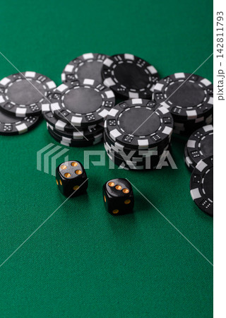 Multicolored casino chips as a conceptual backdrop for gambling games like poker, blackjack Multicolored casino chips as a conceptual backdrop for gambling games like poker, blackjack 142811793
