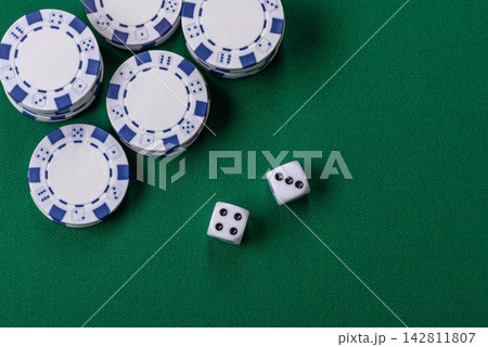 Multicolored casino chips as a conceptual backdrop for gambling games like poker, blackjack Multicolored casino chips as a conceptual backdrop for gambling games like poker, blackjack 142811807