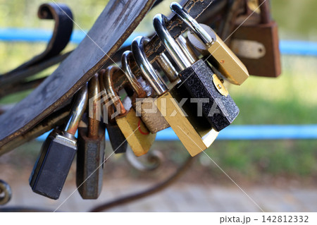 Wedding Love Padlocks Attached to Wrought Iron Bridge Fence. Eternal Love and Marriage Tradition Concept Wedding Love Padlocks Attached to Wrought Iron Bridge Fence. Eternal Love and Marriage Tradition Concept 142812332