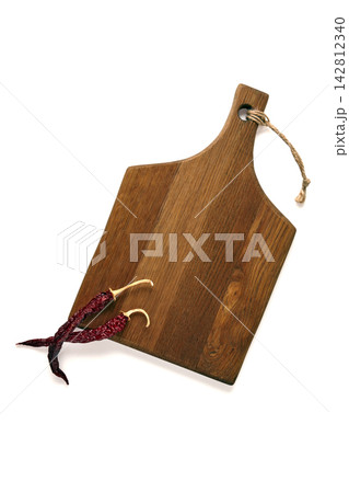 Rustic Wooden Cutting Board with Chili Peppers on White Rustic Wooden Cutting Board with Chili Peppers on White 142812340