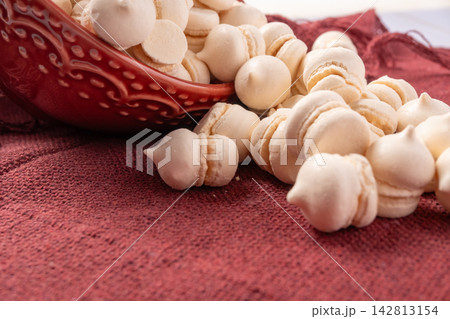 Brazilian sweet meringue, a delicious dessert made of eggs and sugar called "suspiro" in a city in Minas Gerais, Brazil, selective focus. Brazilian sweet meringue, a delicious dessert made of eggs and sugar called "suspiro" in a city in Minas Gerais, Brazil, selective focus. 142813154