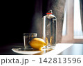 Glass bottle and lemon for refreshing hydration 142813596