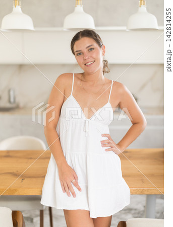 Young woman in dress posing in kitchen 142814255