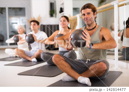Adult man doing pilates with ball 142814477