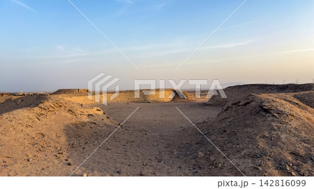 Arid desert landscape with sandy hills under a clear blue sky Arid desert landscape with sandy hills under a clear blue sky 142816099