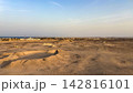 Panoramic view of desert landscape and coastal town 142816101
