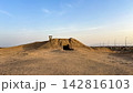 Earthen military bunker embedded in a desert mound 142816103