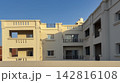 Modern beige residential building under clear blue sky 142816108