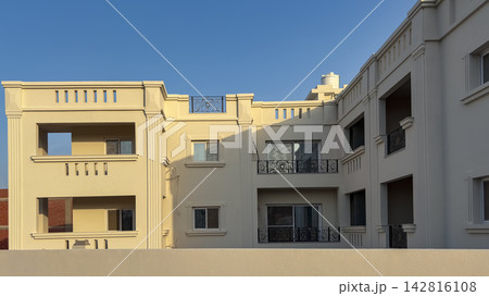 Modern beige residential building under clear blue sky 142816108