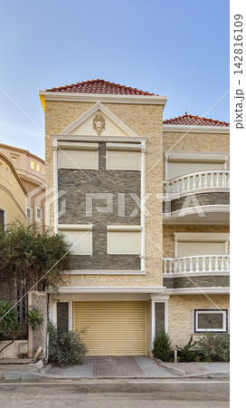 Modern residential villa exterior with garage and shutters 142816109