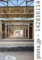 Steel roof framework and brick walls of a building under construction 142816114