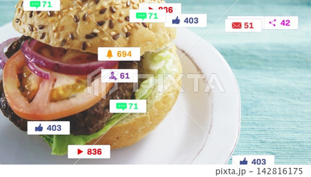 Showing sesame bun burger with lettuce and patty on plate at turquoise mat, badges overlaying Showing sesame bun burger with lettuce and patty on plate at turquoise mat, badges overlaying 142816175