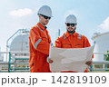 Refinery Engineers Looking Discussion on Blueprint Plan Survey Outdoor Industrial Plant Inspection. 142819109