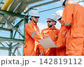 Refinery Engineers Team Working Laptop Outdoor Industrial Plant Technical Discussion. 142819112