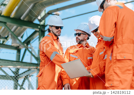 Refinery Engineers Team Working Laptop Outdoor Industrial Plant Technical Discussion. Refinery Engineers Team Working Laptop Outdoor Industrial Plant Technical Discussion. 142819112