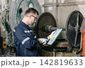 Professional Engineer Worker Schedule Inspecting Machine condition for safety in Heavy Industry Machinery Factory 142819633
