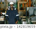 black male factory worker technician standing smiling portrait industrial plant engineer. 142819659