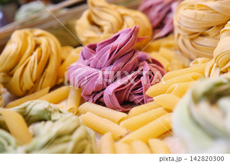 Colorful pasta displayed at a market in the afternoon Colorful pasta displayed at a market in the afternoon 142820300