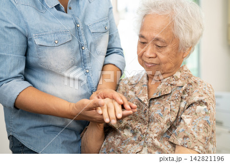 Caregiver help and care Asian senior woman patient with love, encourage and empathy in hospital. 142821196