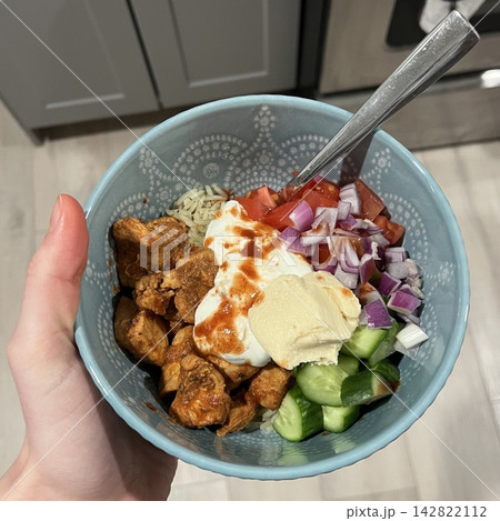 Fresh salad with a mix of crisp leafy greens, sliced vegetables, and colorful ingredients, tossed together to create a healthy, vibrant, and refreshing dish full of natural flavors 142822112