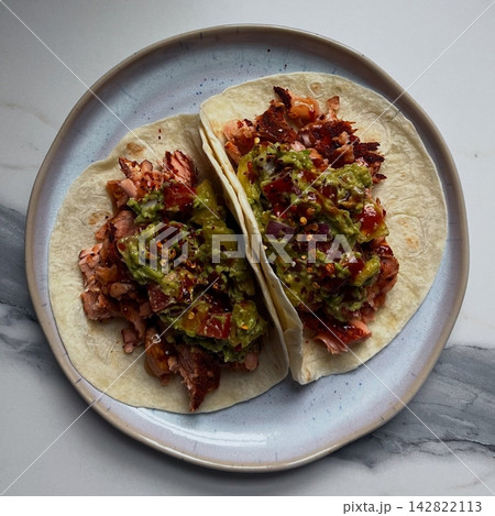 Crispy tacos filled with seasoned meat, fresh lettuce, diced tomatoes, and shredded cheese. A classic Mexican dish perfect for a quick, flavorful meal. 142822113
