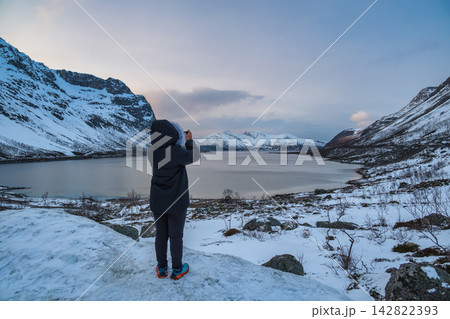 Tromso Norway, woman tourist taking photo of winter nature landscape at Grotfjord Tromso Norway, woman tourist taking photo of winter nature landscape at Grotfjord 142822393