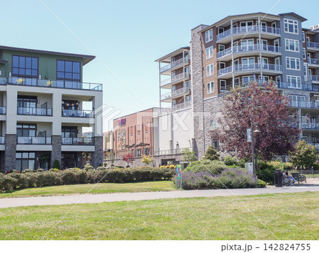 Upscale modern apartment buildings and a park lawn on a sunny day in Ruston, - June 13, 2026 Ruston WA, USA Upscale modern apartment buildings and a park lawn on a sunny day in Ruston, - June 13, 2026 Ruston WA, USA 142824755