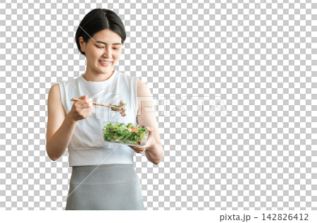 A young woman in sportswear eating a diet menu A young woman in sportswear eating a diet menu 142826412