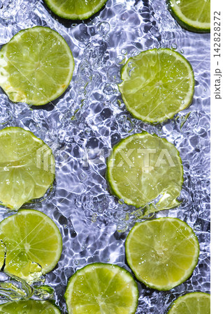 Fresh Lime Slices Floating in Clear Water, Top View Fresh Lime Slices Floating in Clear Water, Top View 142828272