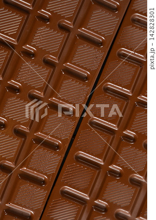 Chocolate bar with geometric line pattern, texture macro background Chocolate bar with geometric line pattern, texture macro background 142828301