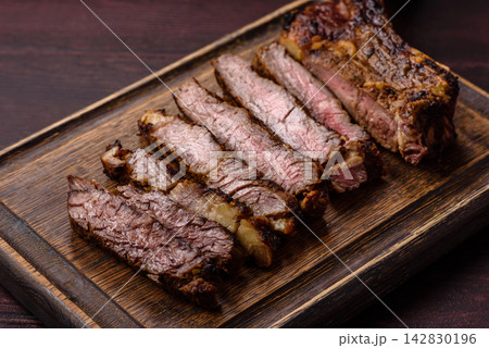 Grilled beef Tomahawk steak seasoned with salt and spices. Tomahawk steak 142830196