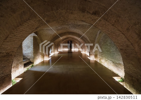 Vaulted stone corridor in the underground baths of the Real Alcazar of Seville Vaulted stone corridor in the underground baths of the Real Alcazar of Seville 142830511