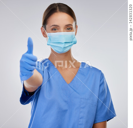 Mask, nurse and woman with thumbs up, portrait and studio for safety, yes and thank you for healthcare. White background, medical and person in mockup, professional and healthy in clinic and expert 142831320