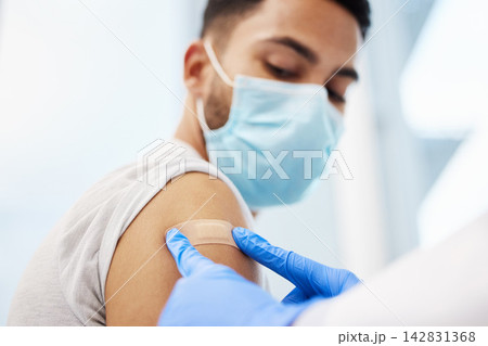 Doctor, man and plaster on arm for injection, healthcare and immunity booster for patient in clinic. Person, bandage and hospital consultation for vaccine, face mask and band aid for influenza shot Doctor, man and plaster on arm for injection, healthcare and immunity booster for patient in clinic. Person, bandage and hospital consultation for vaccine, face mask and band aid for influenza shot 142831368