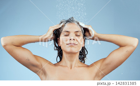 Woman, happy and shower water in shampoo for hair care, wellness and hygiene with eyes closed for skincare. Female person, excited and fresh in blue background or studio in morning routine for beauty 142831385