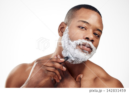 Black man, portrait and shaving cream with razor for beard grooming or hair removal, beauty or white background. Male person, face and facial cleaning for morning self care in studio, mockup or soap 142831459
