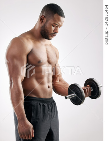 Workout, man and dumbbell in studio with muscles, bodybuilder and exercise for health and wellness training. Bicep, fitness and weightlifting for strength or body goal, power and serious athlete Workout, man and dumbbell in studio with muscles, bodybuilder and exercise for health and wellness training. Bicep, fitness and weightlifting for strength or body goal, power and serious athlete 142831464