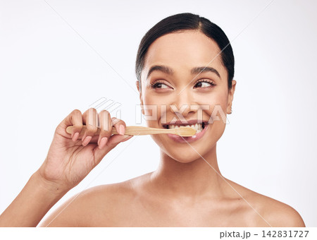 Smile, woman and brushing teeth in studio for dental care, hygiene and fresh breath on white background. Bamboo toothbrush, happy and female person with thinking for cleaning, routine and wellness Smile, woman and brushing teeth in studio for dental care, hygiene and fresh breath on white background. Bamboo toothbrush, happy and female person with thinking for cleaning, routine and wellness 142831727