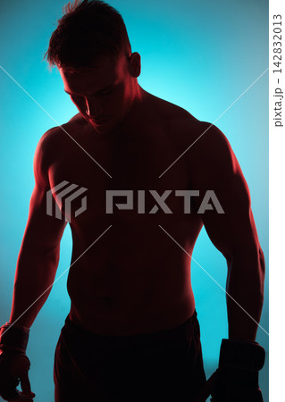 Studio, boxer or man with gloves by blue background for fitness, training and preparation for competition. Male fighter, exercise and workout with planning, thinking and wellness for boxing sports Studio, boxer or man with gloves by blue background for fitness, training and preparation for competition. Male fighter, exercise and workout with planning, thinking and wellness for boxing sports 142832013
