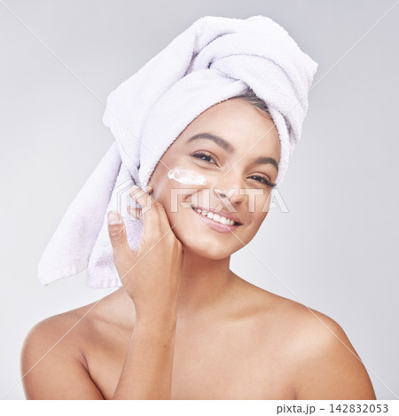 Happy woman, portrait and skincare with cream or ointment for hygiene on a gray studio background. Face of female person or young model with smile for lotion, anti aging or healthy facial treatment 142832053