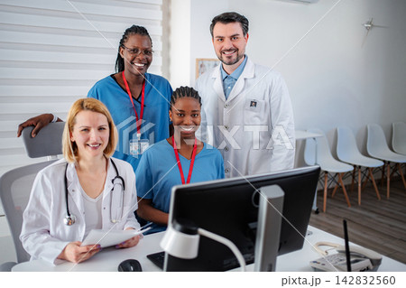 Diverse medical team collaborating in modern office during workday 142832560
