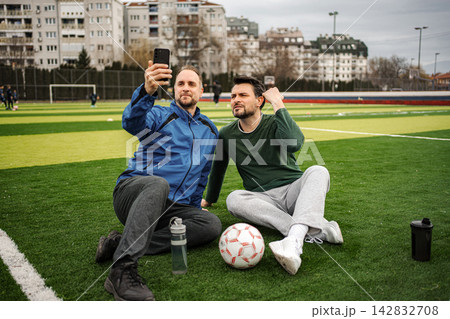 Friends taking selfie on soccer field during break Friends taking selfie on soccer field during break 142832708