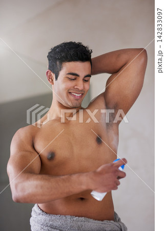 Man, shirtless and deodorant spray in bathroom for morning routine, skincare with shower for perfume. Male person, home and body scent for armpit with smile for wellness, happiness in New York City Man, shirtless and deodorant spray in bathroom for morning routine, skincare with shower for perfume. Male person, home and body scent for armpit with smile for wellness, happiness in New York City 142833097